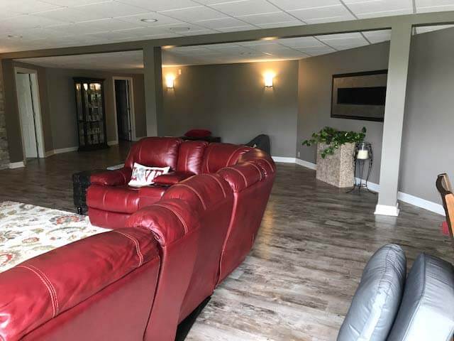 Basement Remodel with stone feature wall and flooring