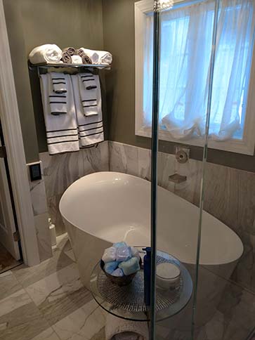 Calcutta Gold Marble bathroom with soaking tub